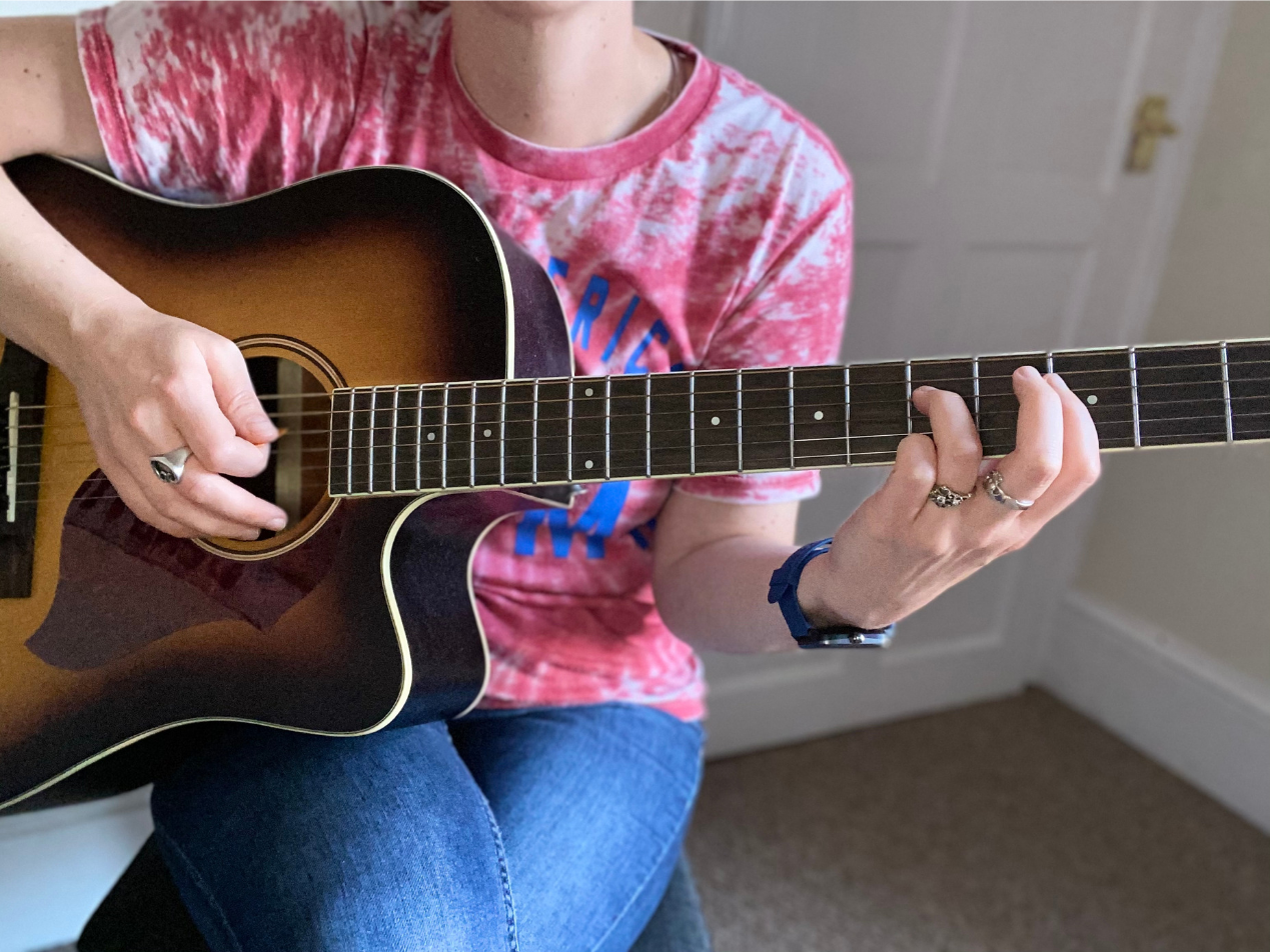 kirsten playing guitar